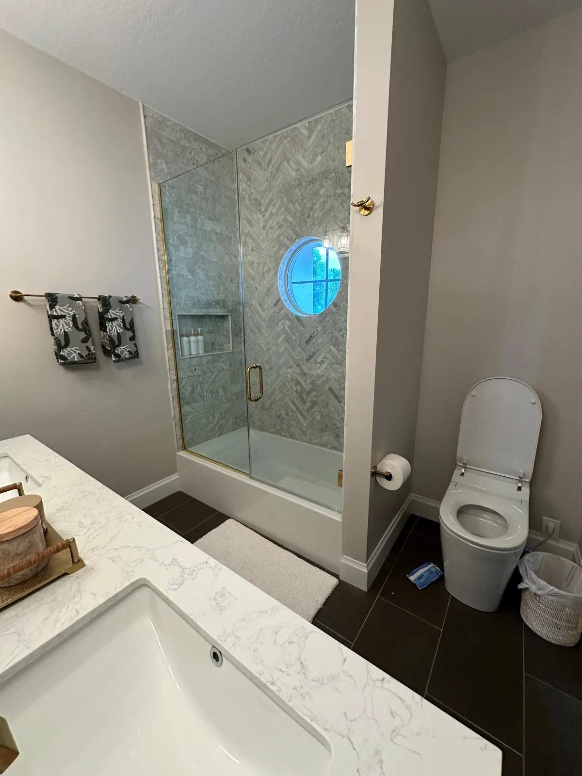 Quartz vanity and glass shower in a remodeled bathroom in Port St Lucie, FL