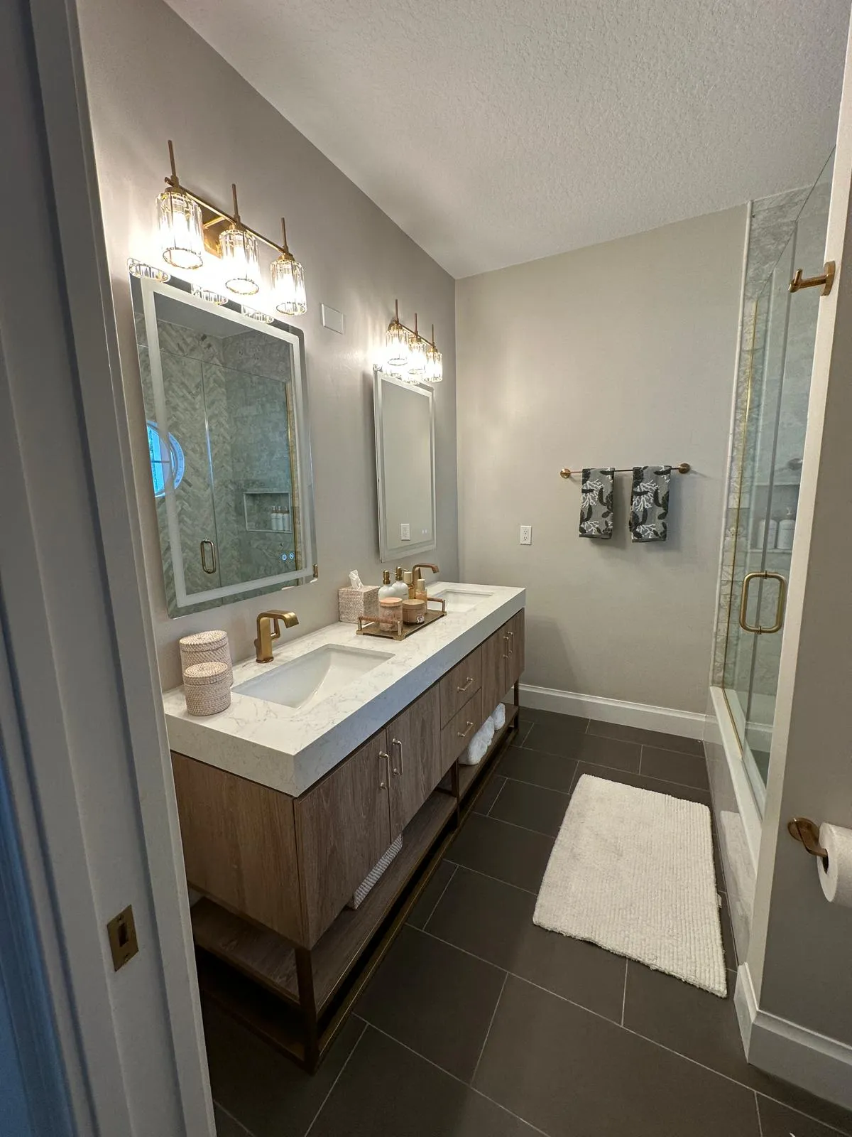 Wood double vanity with lighted mirrors, bathroom remodel in Port St Lucie, FL